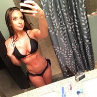 Bruna Lima in a bikini taking a selfie