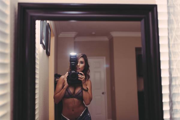 Tianna Gregory in a bikini taking a selfie