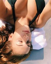 Devin Brugman in a bikini taking a selfie