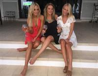 After their sun-drenched day, Nicola and her female friends went out for another break, wearing a very low red gown.