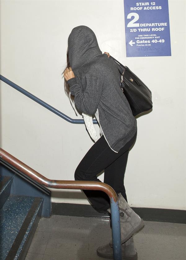 Selena Gomez departing out of LA, hiding her face