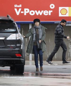 Dannii Minogue - Pictured getting a little wet while filling up on petrol - 09th August 2012