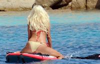 Victoria Silvstedt wearing a bikini on a board in Sardinia on August 8, 2012
