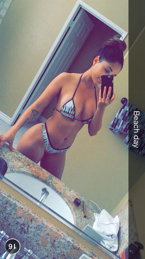 Tianna Gregory in a bikini taking a selfie