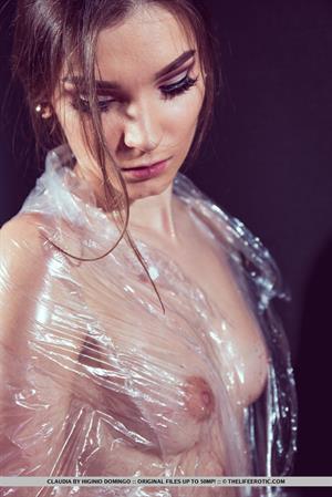 Claudia wraps her sexy, tight body on plastic as she plays with her pussy.