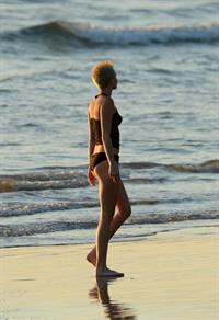 Miley Cyrus  yoga in black bikini on beach in Hawaii 1/24/13 