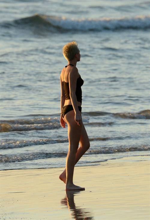 Miley Cyrus  yoga in black bikini on beach in Hawaii 1/24/13 
