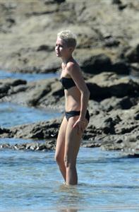 Miley Cyrus  yoga in black bikini on beach in Hawaii 1/24/13 