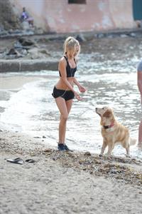 Kimberley Garner in a black bikini on the beach in St. Tropez on July 31, 2014