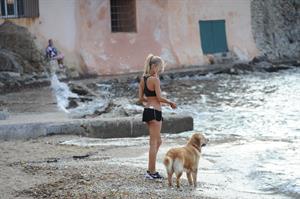 Kimberley Garner in a black bikini on the beach in St. Tropez on July 31, 2014
