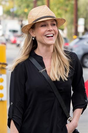 Julie Benz walking in jeans and a hat