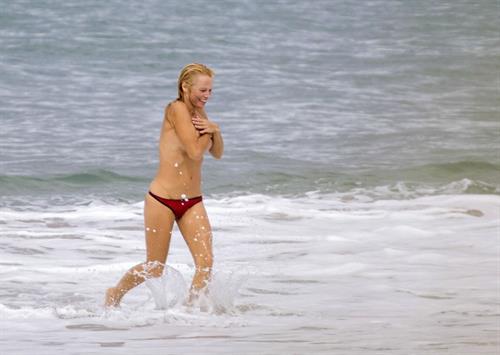 Pamela Anderson Pamela Anderson Going topless at the beach in France 02.10.13
