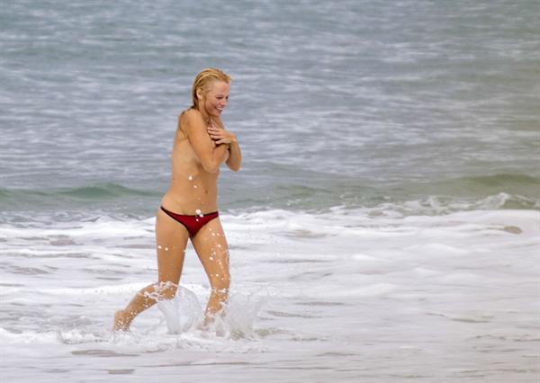 Pamela Anderson Pamela Anderson Going topless at the beach in France 02.10.13