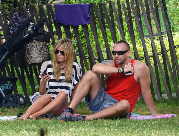 Heidi Klum in a black and white striped shirt, spends a day out in a park in Tribeca on June 30, 2013 