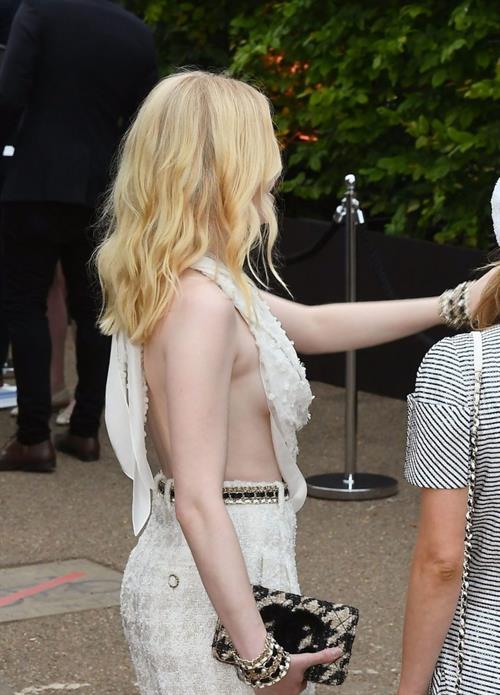 Ellie Bamber Pictures Ellie Bamber braless boobs while wearing basically a scarf as a top showing side boob cleavage.
