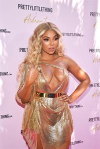 Ashanti sexy cleavage in a low cut dress at the PrettyLittleThings launch party.

