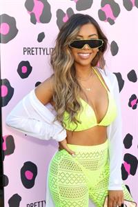 Liane V in a sexy bikini top showing some nice cleavage at the PrettyLittleThings launch party.


