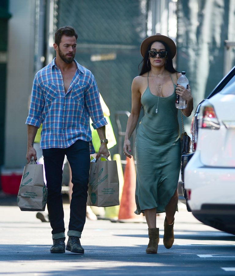 Nikki Bella Pictures Nikki Bella braless boobs in a green dress seen by paparazzi.