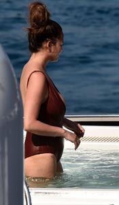 Chrissy Teigen sexy cleavage and ass in a swimsuit with her husband John Legend seen by paparazzi.
