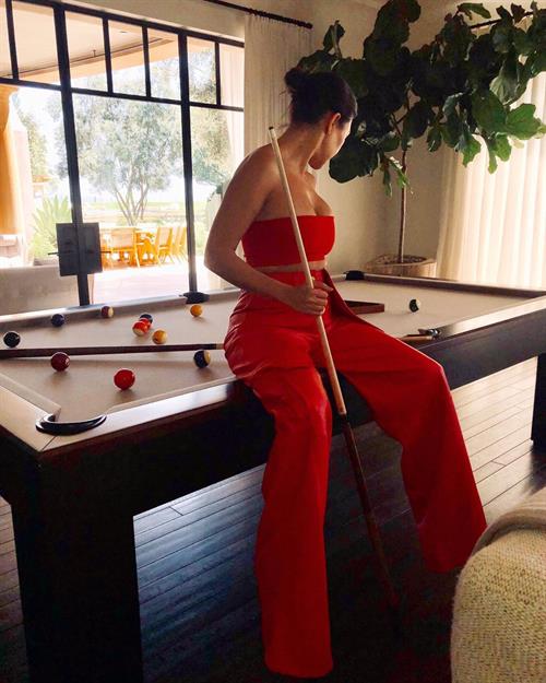 Kourtney Kardashian Pictures Kourtney Kardashian sexy cleavage sitting on her pool table looking like she wants to get fucked on it.