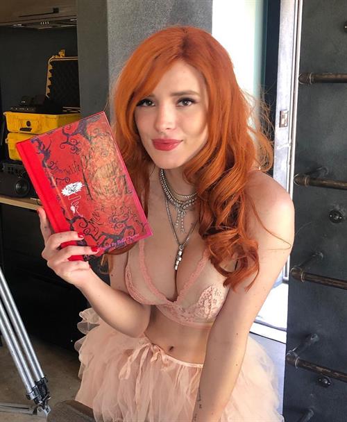 Bella Thorne Pictures Bella Thorne sexy in a see through bra top showing her boobs and cleavage.