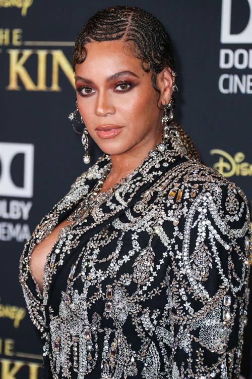 Beyoncé Knowles Pictures Beyonce braless boobs and areola peek showing off nice cleavage on the red carpet for the premiere of The Lion King .