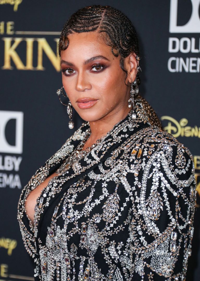 Beyoncé Knowles Pictures Beyonce braless boobs and areola peek showing off nice cleavage on the red carpet for the premiere of The Lion King .
