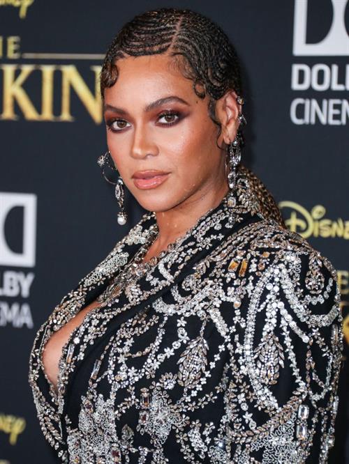 Beyonce braless boobs and areola peek showing off nice cleavage on the red carpet for the premiere of  The Lion King .






