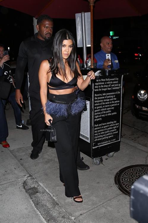 Kourtney Kardashian Pictures Kourtney Kardashian sexy cleavage in a black top seen by paparazzi.