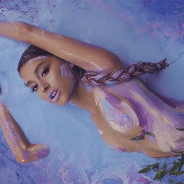 Ariana Grande nude with body paint covering her naked boobs.





































