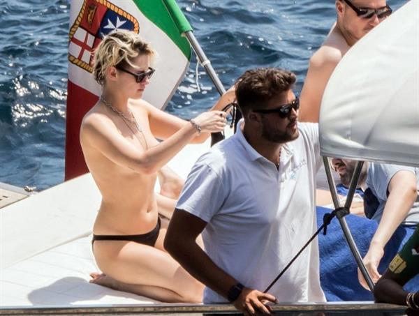 Kristen Stewart nude boobs caught topless by paparazzi tanning on a boat.
