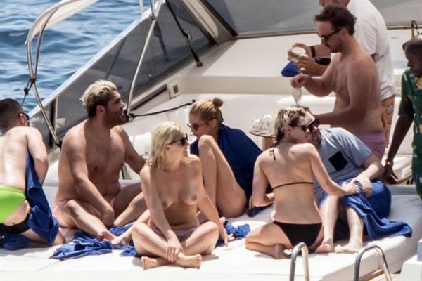 Kristen Stewart nude boobs caught topless by paparazzi tanning on a boat.
