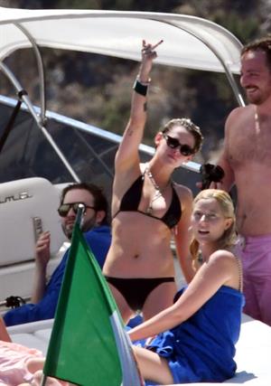 Kristen Stewart nude boobs caught topless by paparazzi tanning on a boat.

