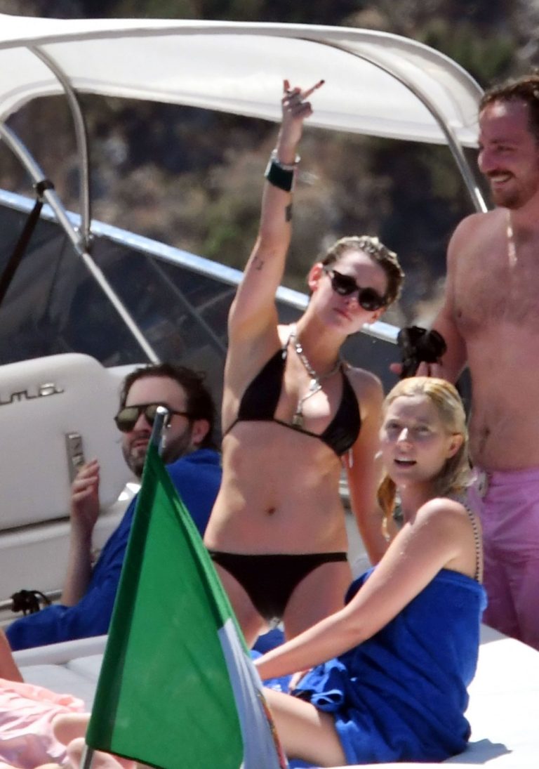 Kristen Stewart nude boobs caught topless by paparazzi tanning on a boat.
