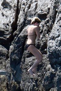 Kristen Stewart nude boobs caught topless by paparazzi tanning on a boat.
