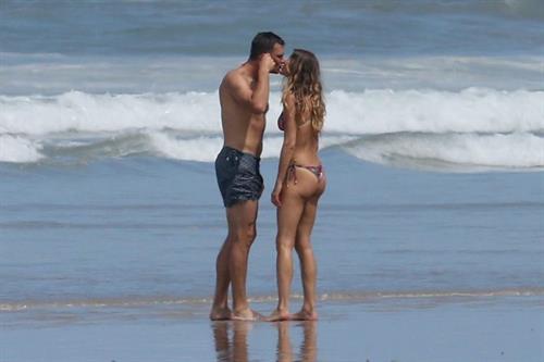 Gisele Bundchen sexy ass in a thong bikini at the beach seen by paparazzi with Tom Brady.

