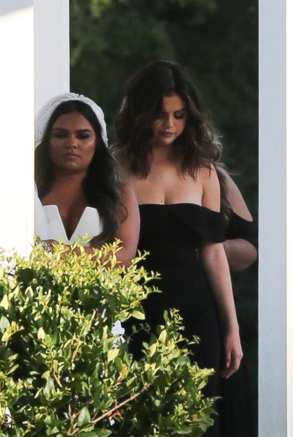 Selena Gomez sexy in a black dress for her cousins wedding showing nice cleavage seen by paparazzi.























