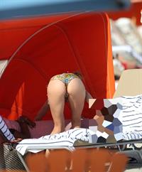 Doutzen Kroes bending over at the beach
