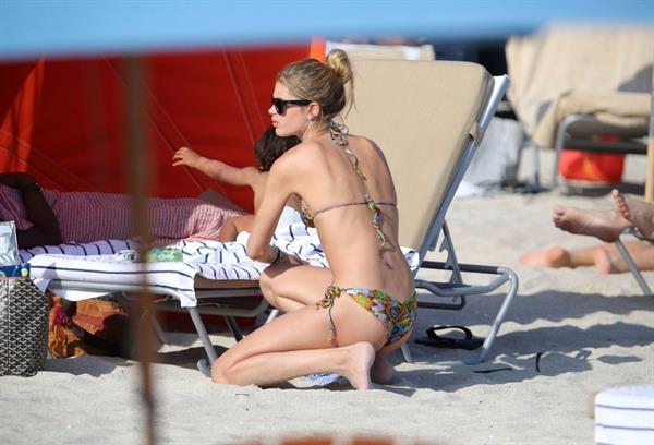 Doutzen Kroes bending over at the beach