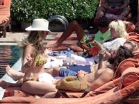 Heidi Klum nip slip in a sexy bikini seen by paparazzi and kissing her husband and flashing her boob.


