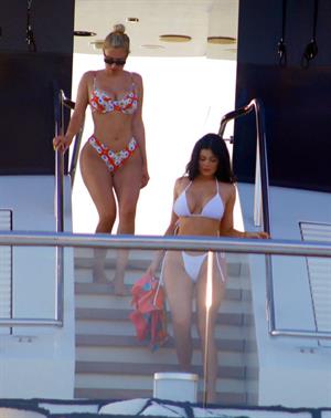 Kylie Jenner sexy ass in a thong bikini also showing nice cleavage seen by paparazzi on her super yacht.
