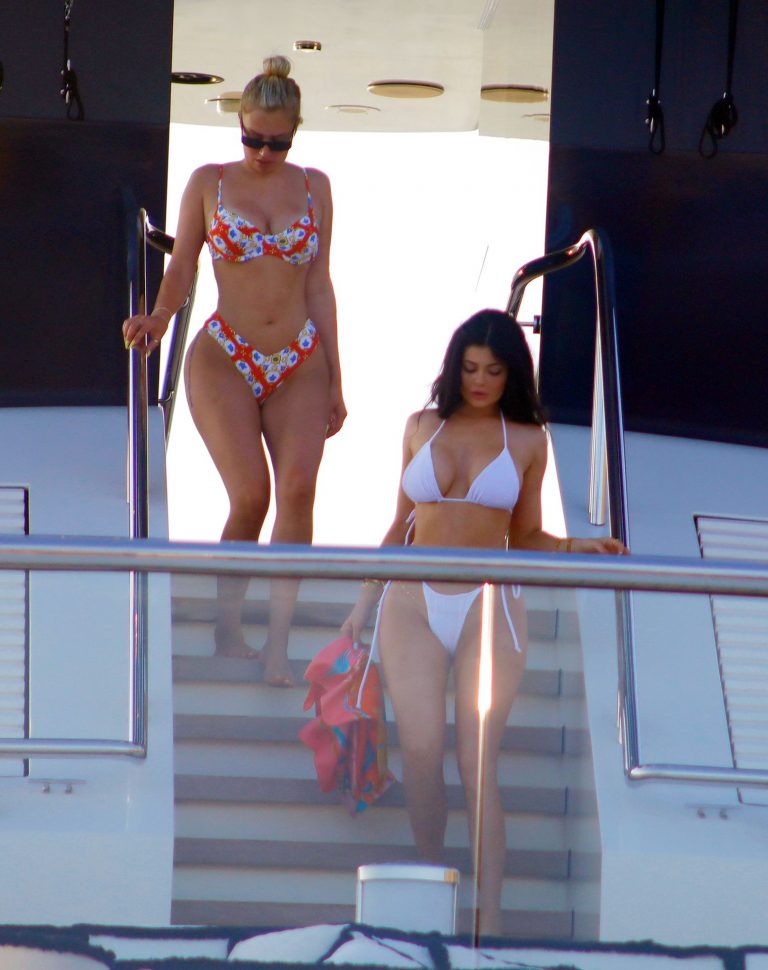Kylie Jenner sexy ass in a thong bikini also showing nice cleavage seen by paparazzi on her super yacht.
