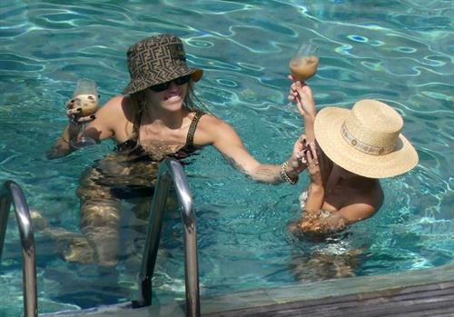 Miley Cyrus and Kaitlynn Carter making out kissing by the pool seen by paparazzi showing her lesbian side after leaving Liam Hemsworth.




