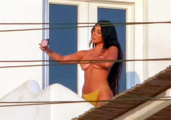 Martha Kalifatidis caught topless by paparazzi with her hand covering her nude big boobs.





