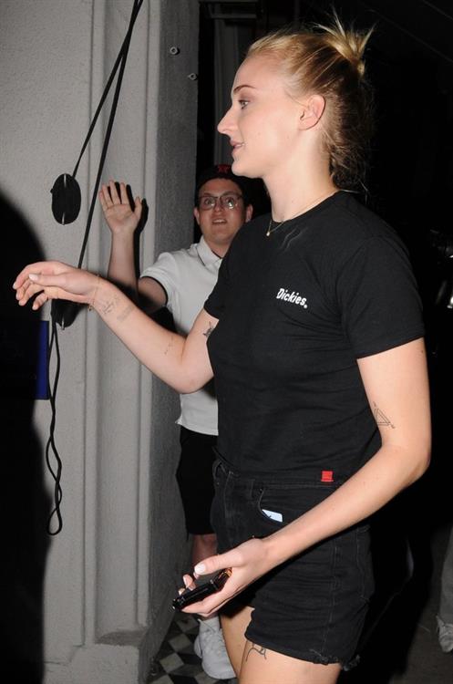Sophie Turner (Actress) Pictures Sophie Turner braless boobs in a black shirt seen by paparazzi showing her tits and her pierced nipple.