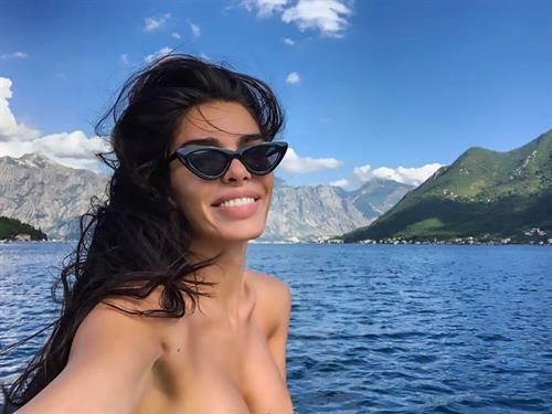 Jovana Djordjevic Selfie Pictures Jovana Djordjevic sexy boobs showing nice cleavage in a pink swimsuit on a yacht.