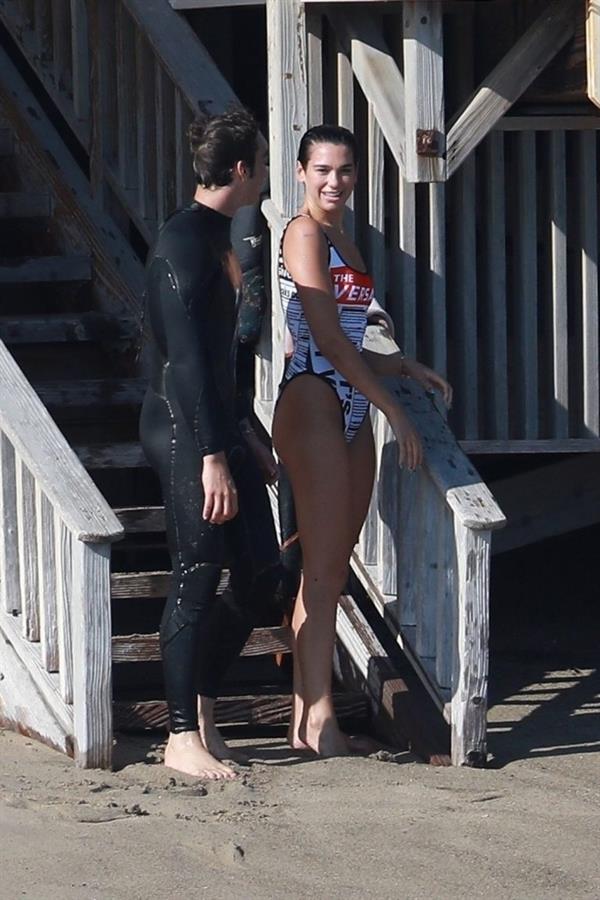 Dua Lipa sexy ass and cleavage in a swimsuit at the beach seen with her boyfriend by paparazzi.













