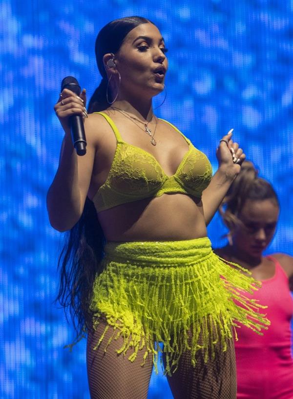 Mabel performing on stage singing in just a bra top showing off her boobs.
















