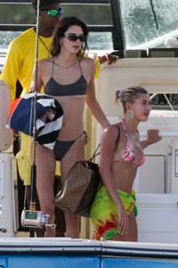 Hailey Bieber, Kendall Jenner and Justine Skye sexy bikini and swimsuit photos seen on a boat drinking for Hailey Bieber's bachelorette party.
