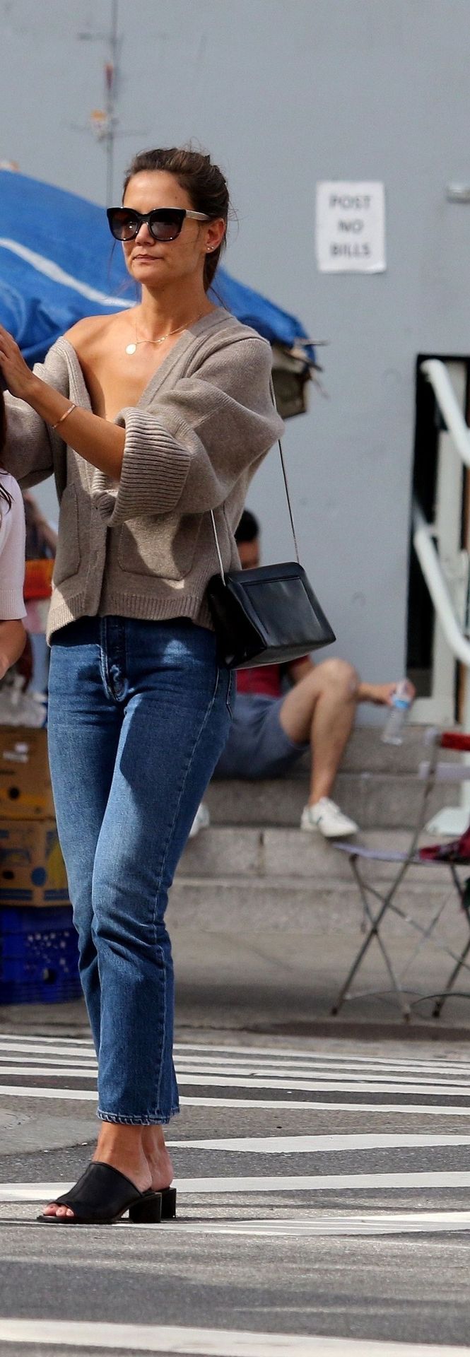 Katie Holmes Pictures Katie Holmes sexy cleavage seen by paparazzi in a revealing outfit.